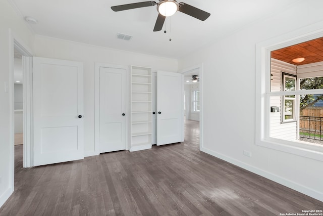 unfurnished bedroom featuring dark hardwood / wood-style flooring and ceiling fan