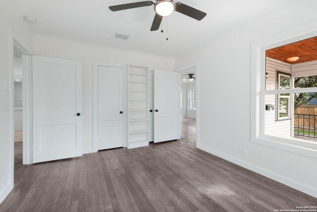 307 Bexar Dr, San Antonio, TX 78228 - unfurnished bedroom featuring dark wood-style floors, baseboards, a closet, and ceiling fan