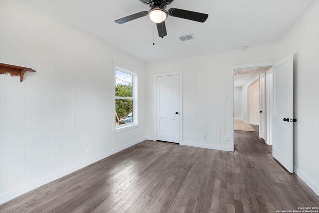 307 Bexar Dr, San Antonio, TX 78228 - unfurnished bedroom featuring wood finished floors, baseboards, and ceiling fan