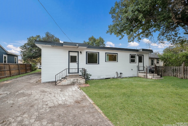 rear view of house with a lawn