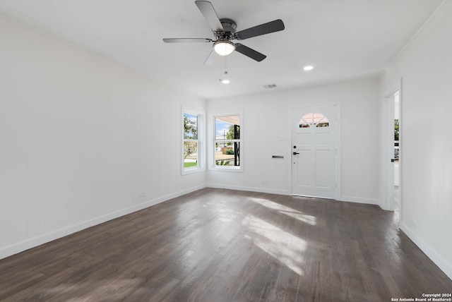 unfurnished room with dark wood-type flooring and ceiling fan