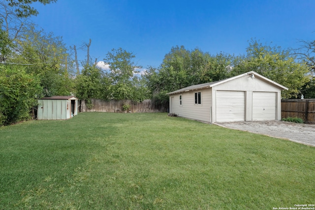 view of yard featuring a garage and a storage shed