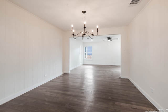 unfurnished dining area with dark wood-type flooring, ceiling fan with notable chandelier, and ornamental molding