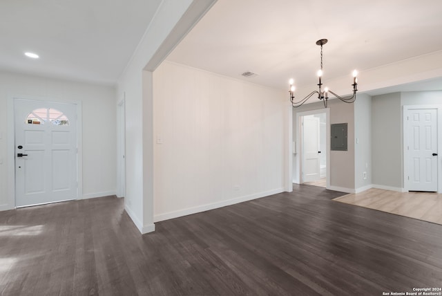 entryway with dark wood-type flooring, electric panel, and an inviting chandelier