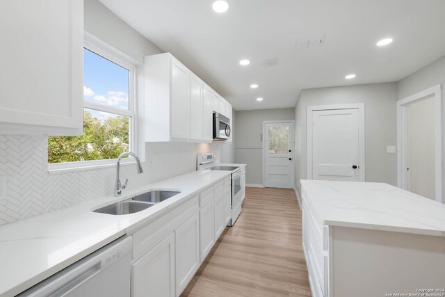 307 Bexar Dr, San Antonio, TX 78228 - kitchen featuring white appliances, a sink, recessed lighting, backsplash, and white cabinetry
