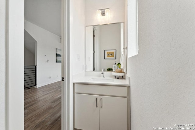 3214 N Elmendorf St, San Antonio, TX 78201 - bathroom featuring vanity, wood finished floors, and a textured wall