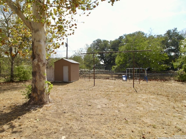 view of yard with a playground and a shed