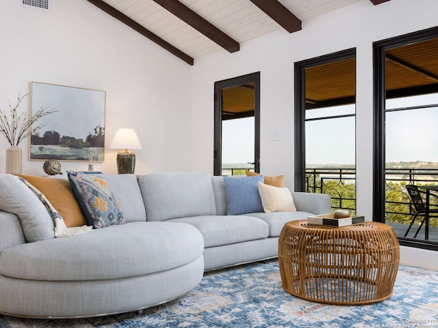 living room with plenty of natural light, wood ceiling, and lofted ceiling with beams