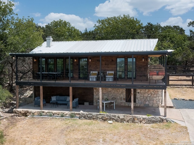 1941 Lakeshore Dr, Canyon Lake, TX 78133 - back of house featuring an outdoor hangout area, a patio, metal roof, fence, and a chimney