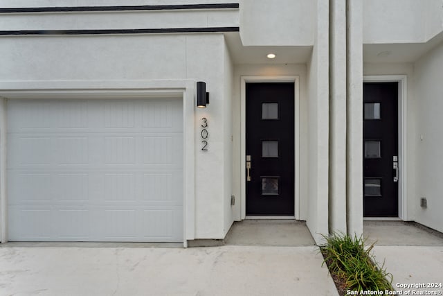 doorway to property with a garage