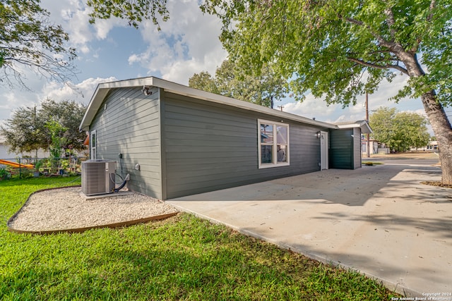 view of side of home featuring central air condition unit and a patio