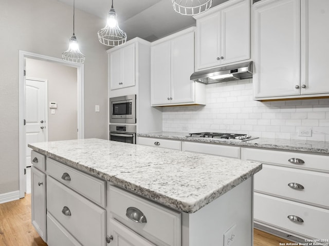 kitchen featuring white cabinetry, decorative backsplash, light hardwood / wood-style floors, and stainless steel appliances