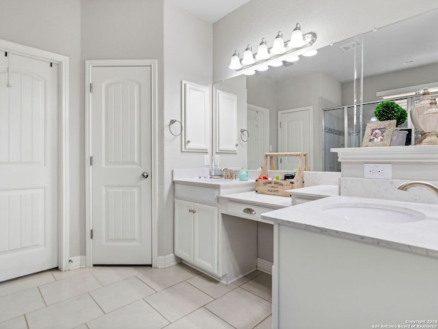 bathroom featuring an enclosed shower, vanity, and tile patterned flooring