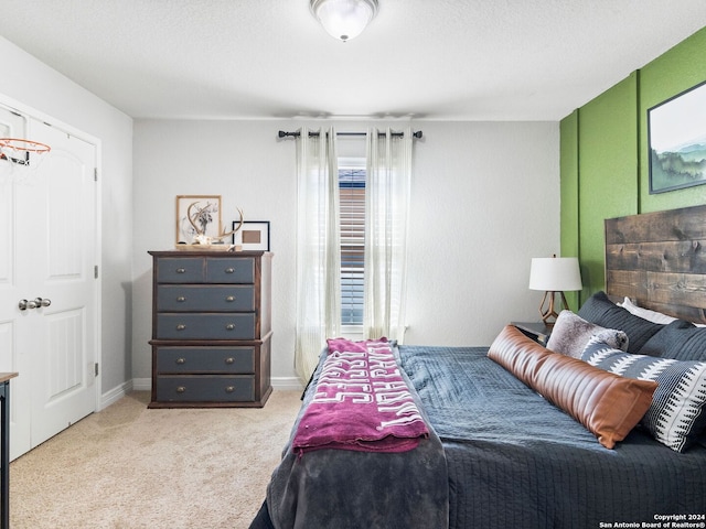 carpeted bedroom with a textured ceiling