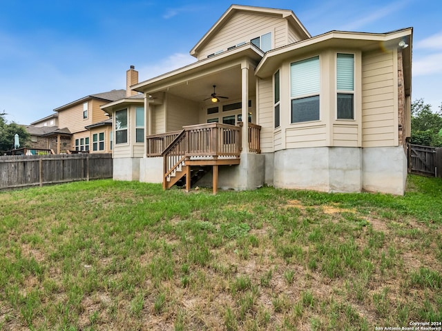 back of property with a lawn and ceiling fan