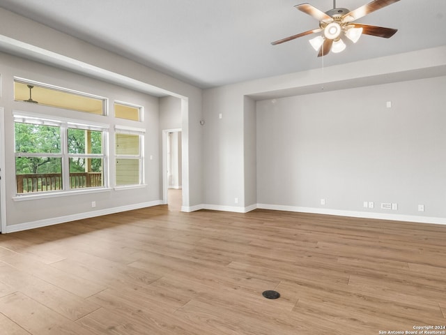 empty room featuring ceiling fan and light wood-type flooring