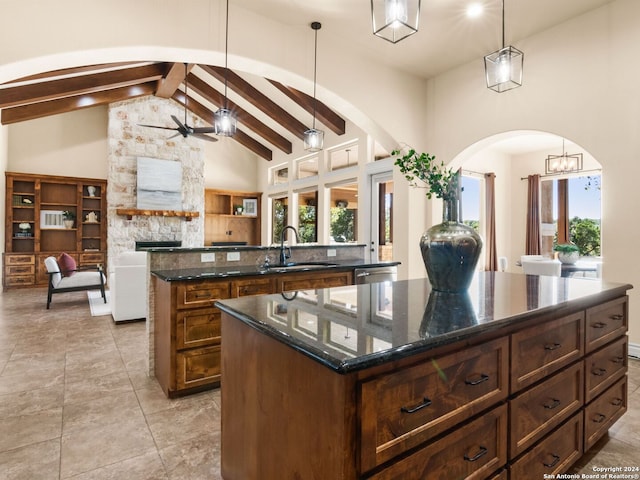 kitchen with a wealth of natural light, pendant lighting, and a center island