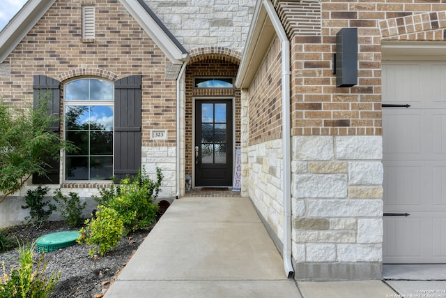 view of exterior entry with a garage