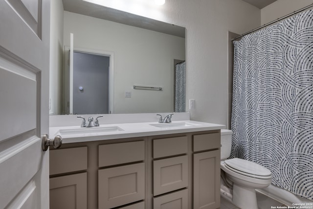 bathroom featuring toilet, vanity, and walk in shower