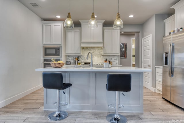 323 Sugarcane, New Braunfels, TX 78132 - kitchen featuring appliances with stainless steel finishes, light countertops, backsplash, white cabinetry, and recessed lighting