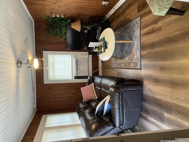 living room featuring hardwood / wood-style flooring, wooden walls, and wood ceiling