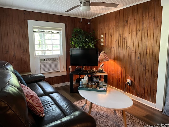 living room with cooling unit, crown molding, and wooden walls