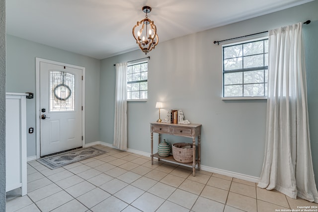 foyer with a notable chandelier and light tile patterned flooring