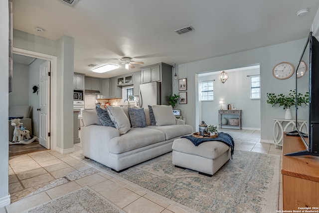 living room with light tile patterned flooring and ceiling fan