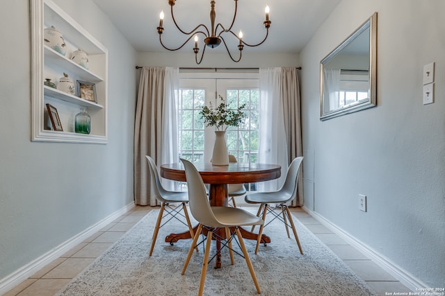 dining space with a notable chandelier and light tile patterned floors