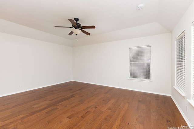 spare room with dark hardwood / wood-style floors, ceiling fan, and vaulted ceiling