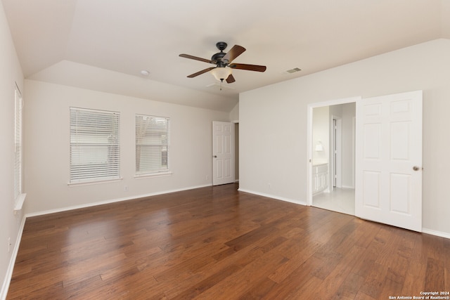 interior space featuring dark hardwood / wood-style flooring, vaulted ceiling, ceiling fan, and ensuite bathroom