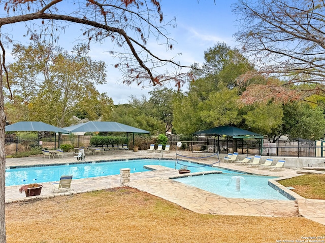 view of pool featuring a lawn and a patio area