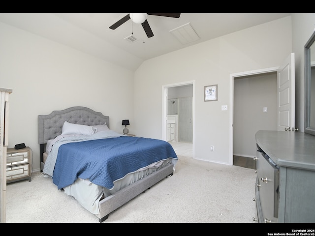 carpeted bedroom with vaulted ceiling, ceiling fan, and ensuite bathroom