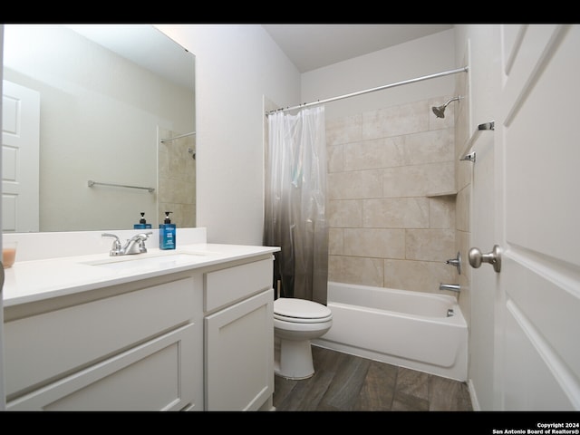 full bathroom with hardwood / wood-style flooring, vanity, toilet, and shower / bathtub combination with curtain