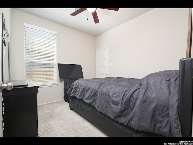 bedroom featuring ceiling fan and light carpet