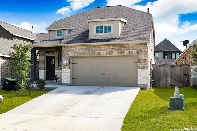 view of front of property featuring a garage and a front yard