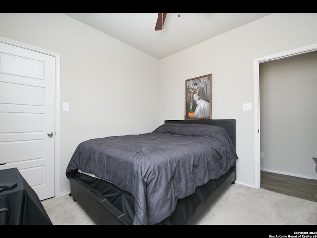 bedroom featuring light carpet and ceiling fan