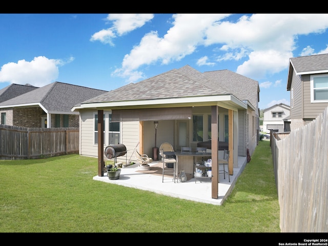 back of property with a patio and a yard