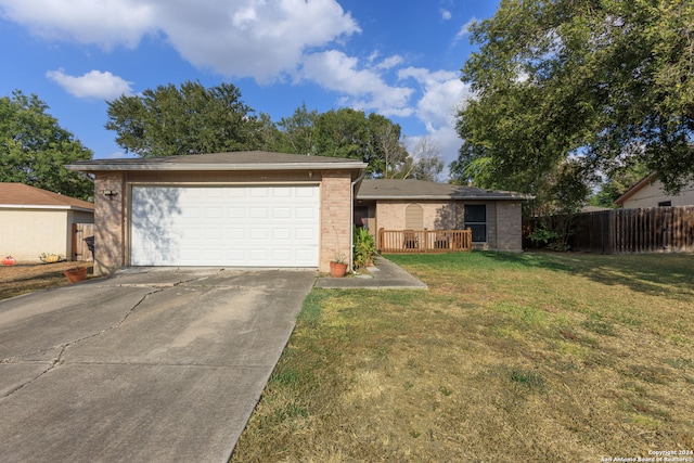 ranch-style house with a garage and a front lawn