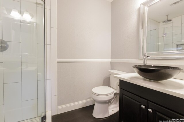 13618 Primwood St, San Antonio, TX 78233 - bathroom featuring a stall shower, toilet, vanity, and baseboards