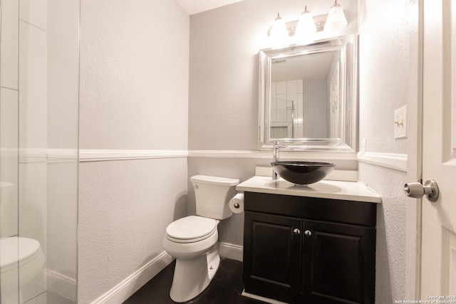 13618 Primwood St, San Antonio, TX 78233 - full bath with toilet, vanity, a textured wall, and baseboards