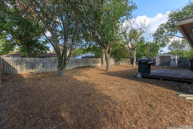 13618 Primwood St, San Antonio, TX 78233 - fenced backyard featuring a shed, an outbuilding, and a wooden deck