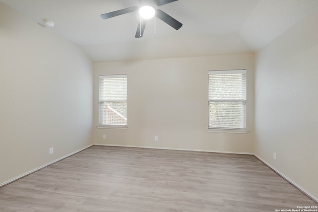 empty room featuring light hardwood / wood-style floors, a healthy amount of sunlight, and lofted ceiling