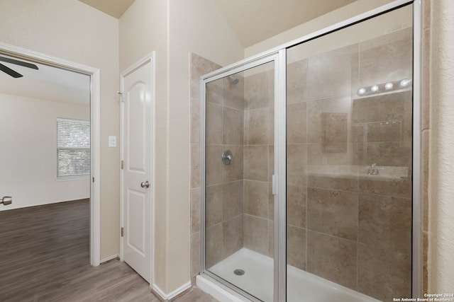 bathroom with hardwood / wood-style flooring, ceiling fan, a textured ceiling, and walk in shower