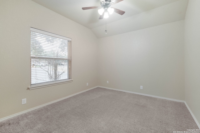 unfurnished room featuring vaulted ceiling, ceiling fan, and carpet floors