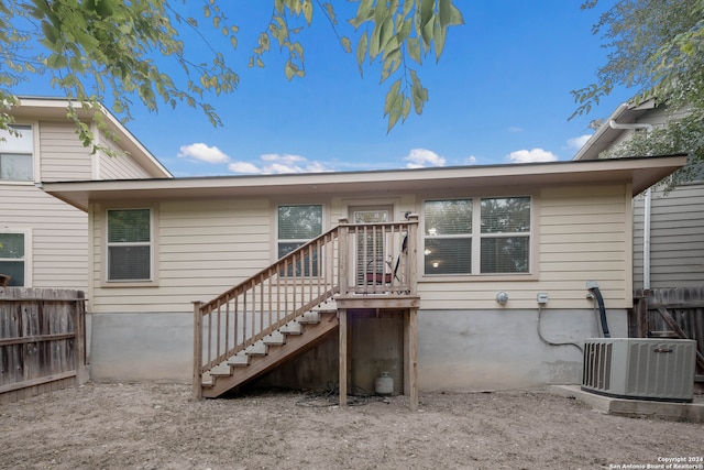 rear view of property with central AC unit