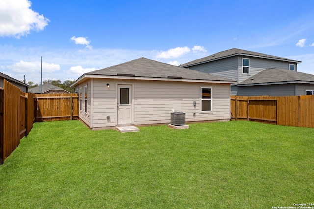 rear view of house with a yard