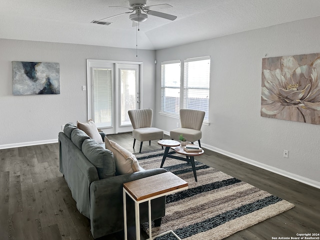 living room with ceiling fan and dark hardwood / wood-style flooring