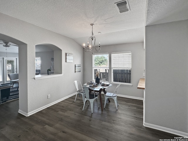 dining space featuring vaulted ceiling, a textured ceiling, ceiling fan with notable chandelier, and dark hardwood / wood-style floors