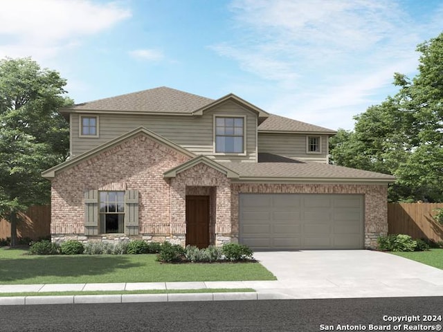 view of front of home featuring a front yard and a garage